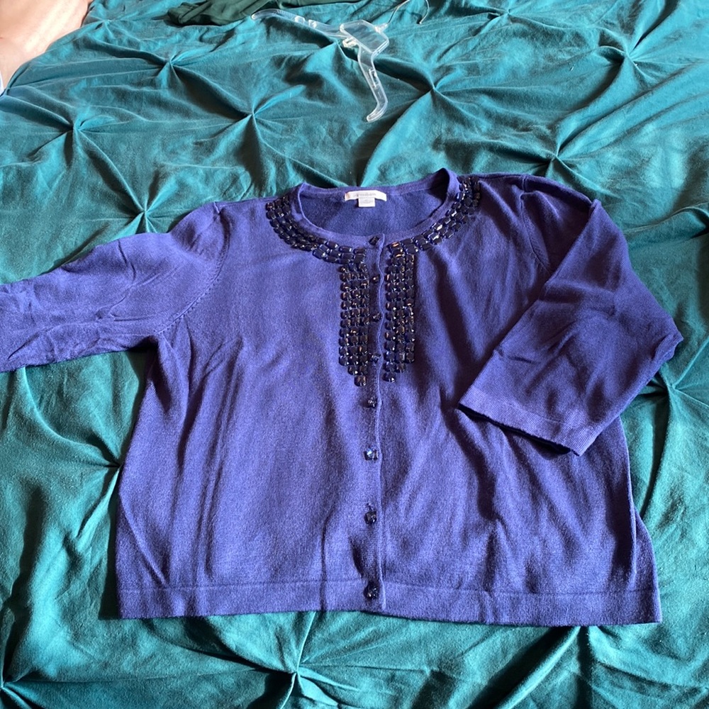 Navy cardigan with faux gemstone neckline.